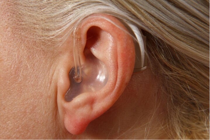 Close up image of discrete hearing aid in woman's ear