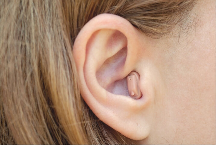 Close up image of discrete hearing aid in woman's ear