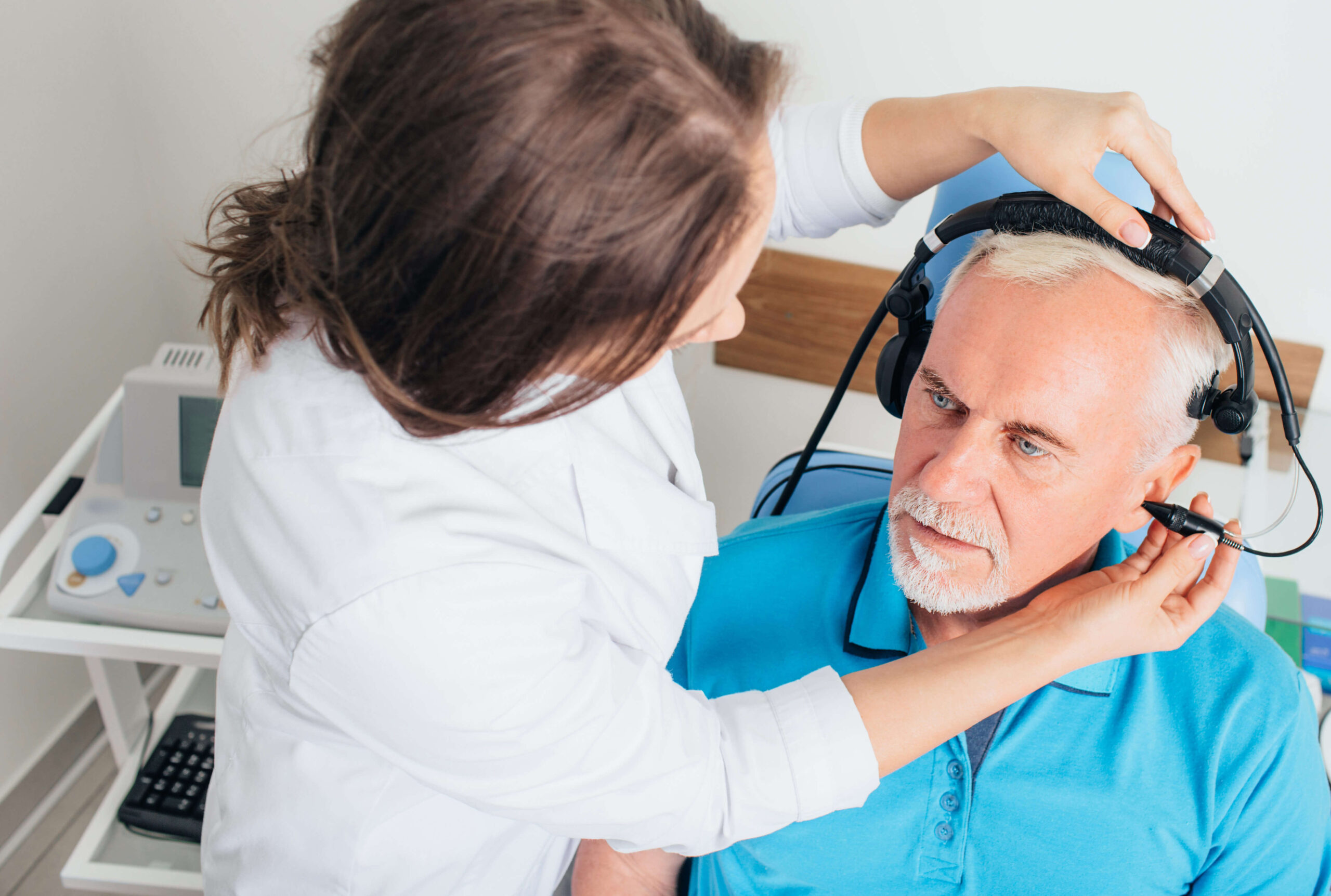 doctor performing an ear test on patient