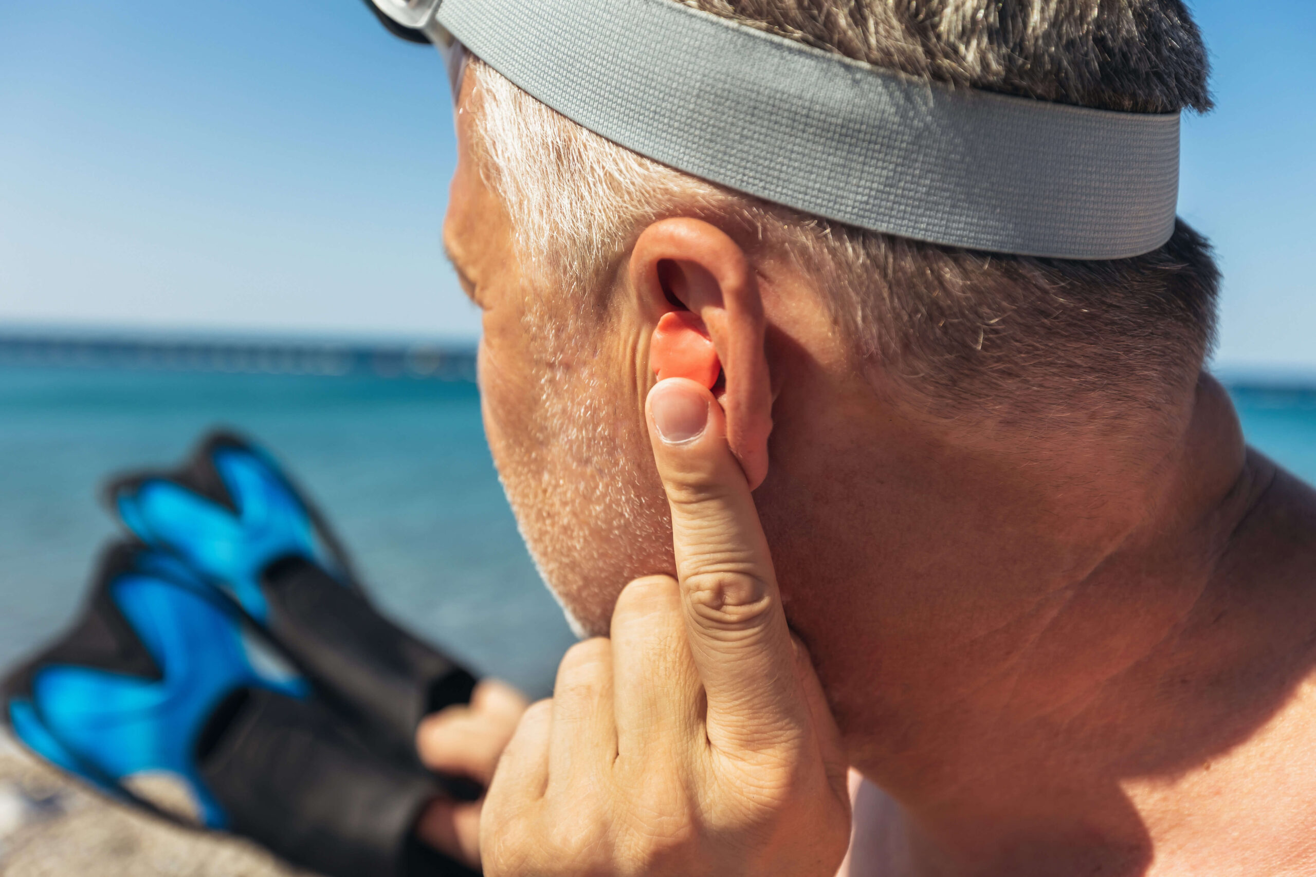 man enjoying time at the beach with his hearing aid